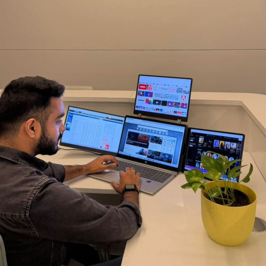 Professional using the RIITEK 14-inch quad portable monitor for multitasking, trading, and office productivity.
