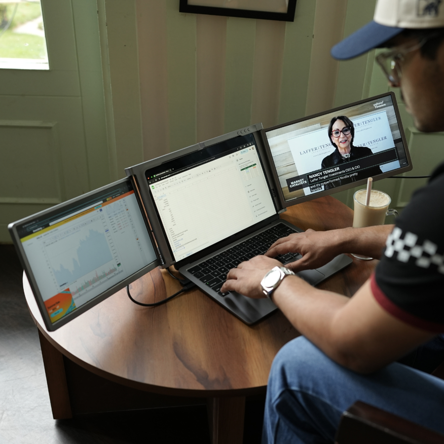 Trader Professional using RIITEK 14 inch tri screen laptop screen extender for trading and productivity