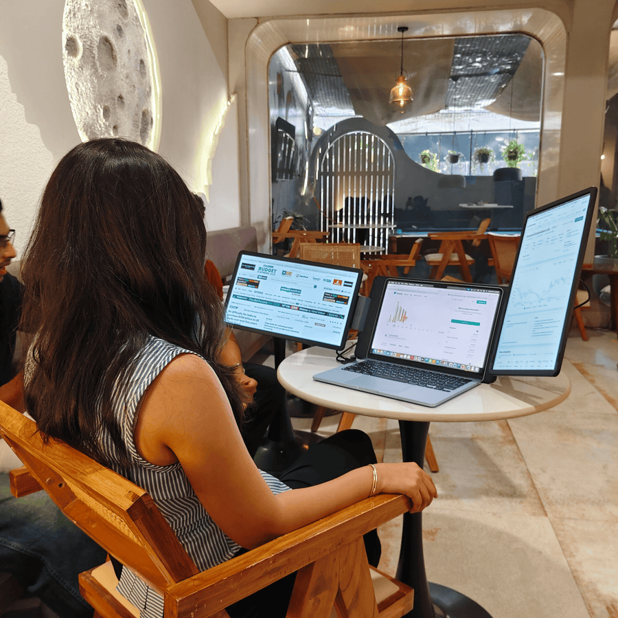 Professional using RIITEK 15.6 inch Tri Screen Monitor portable monitor for laptop while working remotely with three screens.